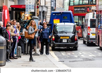 London, UK - September 12, 2018: Bus Stop On Street Road In Aldwych With People Young Woman Waiting In City Downtown Busy Traffic