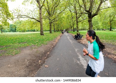 London, UK - September 12, 2018: Alley Path In Green Park With Benches In Westminster City With Woman Running Or Jogging In United Kingdom