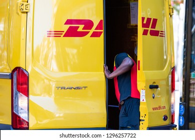 London, UK - September 13, 2018: Closeup Of DHL Delivery Truck In Chelsea Area Of City With Man Opening Back Door On Street Outside