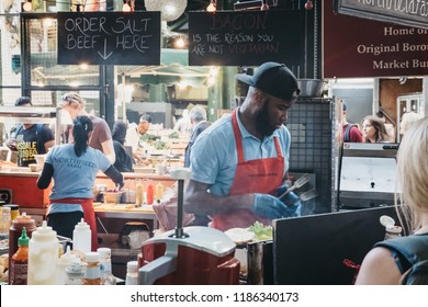 London, UK - September 17, 2018: Staff Preparing Food At Northfield Butchery Market Stand In Borough Market, One Of The Largest And Oldest Markets In London, UK.