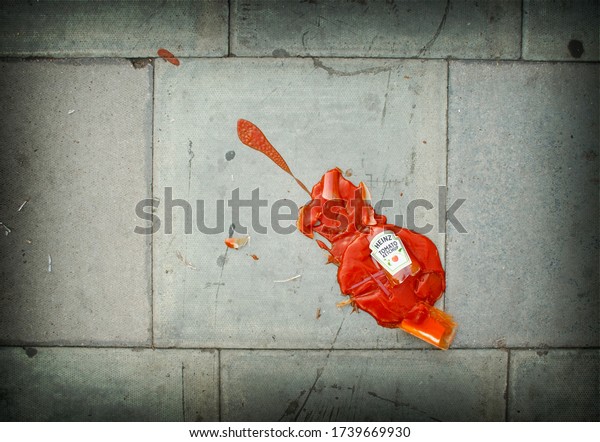 London, UK / September 19 2009:  Smashed Heinz tomato ketchup bottle with spaltter in a violin shape on the sidewalk / pavement.