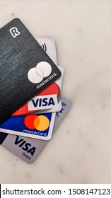 London, UK - September 2019: Starling, Revolut, Visa Debit Business And Personal Banking Credit Cards Comparison. Mastercard Logo. Plastic And Metal. New Challenger Bank Fintech With Mobile App. Spend