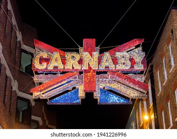 London, UK - September 21st 2019: Illuminated Street Sign Above Carnaby Street, London, W1, Centre Of The London Swinging 60s Fashion Scene.