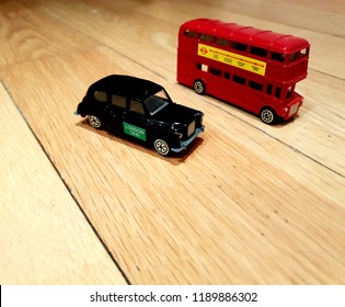 London, UK, September 26th 2018: Model London Bus And Taxi Side By Side On Wooded Floor 