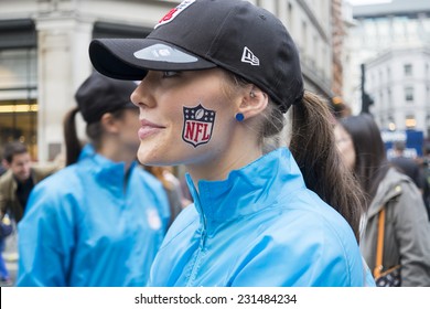 LONDON UK - SEPTEMBER 27: Profile portrait of beautiful girl with NFL logo painted on cheek. September 27 2014 in London. The street was closed to traffic to host NFL related games and events.