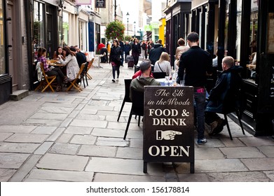 London, UK - September 29, 2013: People Enjoy Outdoor Dining On The Street At The Angel  The Borough Has One Of The Highest Density Of Bars, Restaurants And Pubs In Central London. Sign Food And Drink