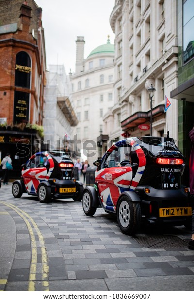 London, UK - September 30, 2020: Portrait View of\
Small Cars Painted as the British Flag and Used for GPS Guided\
Audio Tours around London,\
UK