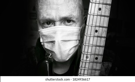 London, UK / SEPTEMBER 30th 2020 : Guitar Teacher Wearing Face Mask For Personal Protection During Covid19 Pandemic.