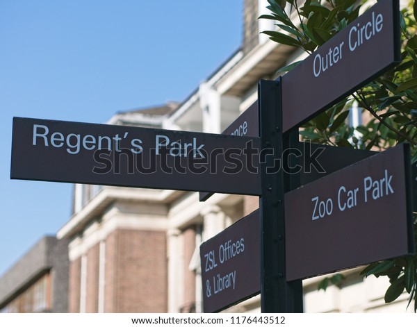 London, UK - September 6, 2018: Street direction\
sign pointing at Regent\'s Park, Zoo Car Park, ZSL Offices &\
Library and Outer\
Circle.