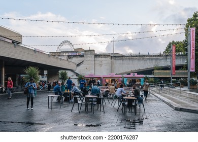 London, UK - September 8, 2022: People At The Outdoor Tables Of Serving Up Summer KERB Food And Drink Stalls By The National Theatre On South Bank, An Area Beside The River Thames Famous For Theatres.