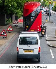 London. UK-05.16.2020: A Double Decker Bus, Mini Van And Learner Motorcyclist On Camden Road. As The Government Eases The Corona Virus Lockdown And Urged A Return To Work, Road Traffic Have Increased.