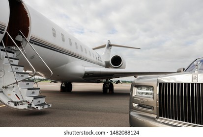 London, UK-7 MAY, 2019: Private executive airplane with limousine Rolls Royce Phantom luxury car shown together at international Heathrow Airport. VIP service at the airport. Business-class transfer.