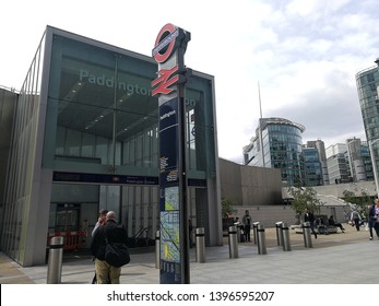 LONDON, UK-7 MAY 2019: Undefined people in front of Paddington station and the signs pillar . It is the newest gate to get into the train and underground station in London, United Kingdom