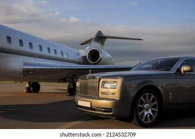 London, UK-7 MAY, 2021: Private Executive Airplane With Limousine Rolls Royce Phantom Luxury Car Shown Together At International Heathrow Airport. VIP Service At The Airport. Business-class Transfer.