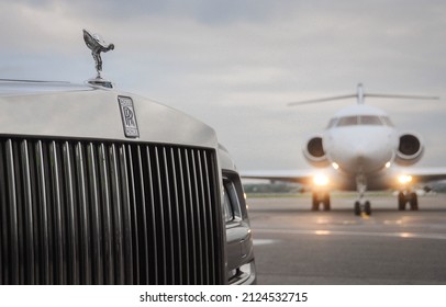 London, UK-7 MAY, 2021: Private executive airplane with limousine Rolls Royce Phantom luxury car shown together at international Heathrow Airport. VIP service at the airport. Business-class transfer.