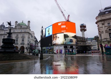 LONDON, UK-9.2.2021: Piccadilly Circus in wet, snowing and quiet London lockdown day. It is a famous road junction and public space of London's West End in the City of Westminster, built in 1819 