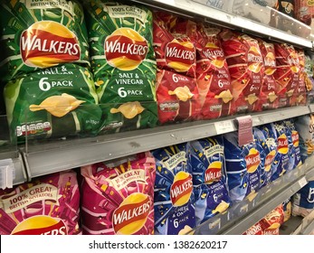 London, UK/April 27, 2019: Packets Of Walkers Crisps On Shelves In A Supermarket. Walkers Is A Leading Food Company In UK.