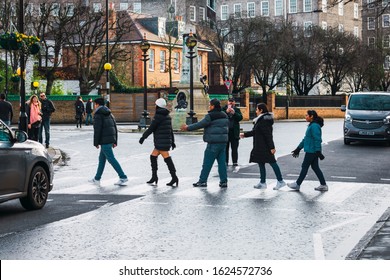 London, UK/Europe; 22/12/2019: People Crossing The Famous Crosswalk Of Abbey Road, Cover Of The Beatles Album 