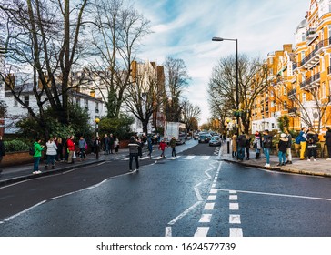 London, UK/Europe; 22/12/2019: People Crossing The Famous Crosswalk Of Abbey Road, Cover Of The Beatles Album 