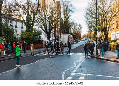 London, UK/Europe; 22/12/2019: People Crossing The Famous Crosswalk Of Abbey Road, Cover Of The Beatles Album 