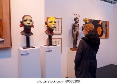 LONDON, UK-JANUARY 23: A visitor to the prestigious London Art Fair showing contemporary and modern art, looking at sculpture by artist Cathy Lewis. January 23, 2011 in London, UK.