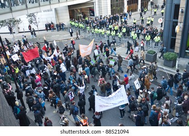 LONDON, UK-NOVEMBER 9: Student Demonstrators Carrying Banners Protest Against Fee Increases, March Past Police Manning Barriers To Stop Them From Entering The Stock Exchange On November 9, 2011 In London UK