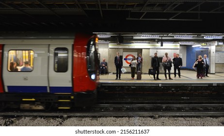 A London Underground Tube Train Arrives At Victorian Station As Passengers Wait On A Platform On June 16, 2015 In London, UK.