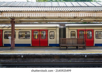 A London Underground tube train waiting at an empty platform - Powered by Shutterstock