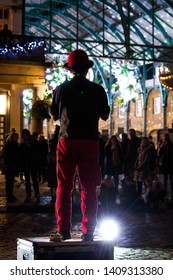 London, United Kingdom - 01/01/2019: A Busker Performing In Covent Garden At Night