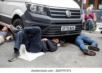 London, United Kingdom, 21st August 2021:- Extinction Rebellion protesters block traffic by laying under a van