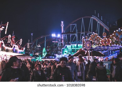 London, United Kingdom - 31 Dec 2016: The crowd in the amusement park at Winter Wonderland. The amusement park is decorated with lights.