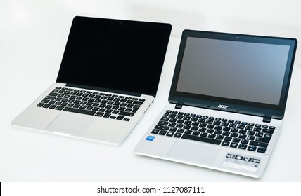 LONDON, UNITED KINGDOM - Apple Mac Book Pro And Acer Aspire Laptop Notebook Next To Eachoterh On White Table