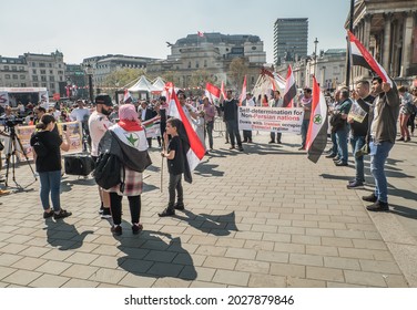 London, United Kingdom - Apr 19, 2019 : View Of People With Placards And Syrian Flag On Global Strike For Down With Iranian Occupied Terrorist Regime At Trafalgar Square. Selective Focus.