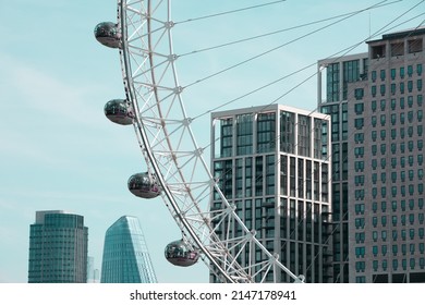 London, United Kingdom - April 15, 2022: The London Eye in front of the Southbank Place luxury apartments.