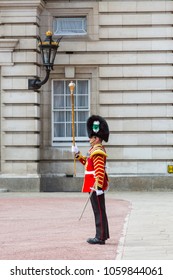 London, United Kingdom - April 23, 2015: A Drum Major Carries A Mace While Guiding A Military Band In The Grounds Of Buckingham Palace.