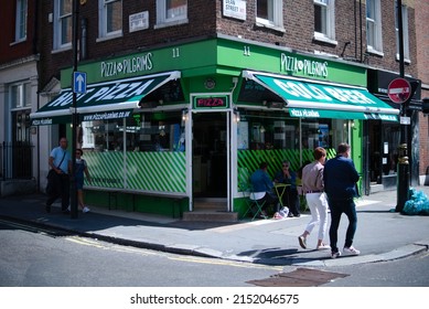 LONDON, UNITED KINGDOM - Aug 14, 2019: The Shop Of Pizza Pilgrims From Outside The Front Door People Walking By On A Sunny Day In London City