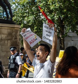 London, United Kingdom - August 17,  2019: Chinese man holding a banner against those supporting the UK Solidarity with Hong Kong Rally. 