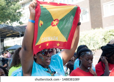 London, United Kingdom, August 25th 2019:-A  Reveller With The Flag Of Grenada At The Notting Hill Carnival In West London, The Notting Hill Carnival Is Europe's Largest Street Party.