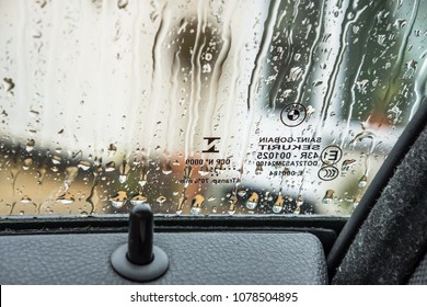 London, United Kingdom - Circa April 2018: Shallow Focus, Inside View Of The Driver's Window Markings And Rain Droplets Seen In A Prestige, German Made Car. The Car Is Unlocked Due To The Upright Tab.