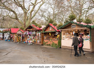  LONDON, UNITED KINGDOM - December 10: Christmas market with small shops selling Christmas gifts and people around at Winter wonderland in Hyde Park on December 10 2015, London UK 
