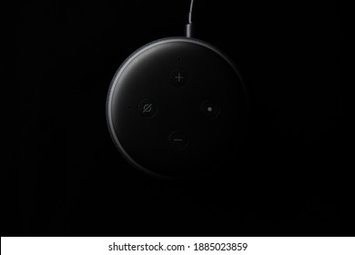 London, United Kingdom - December 19 2020: Close-up Of An Amazon Echo Dot Smart Speaker With Built-in Alexa Voice Assistant On A Black Background.