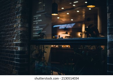 LONDON, UNITED KINGDOM - Feb 14, 2022: A Peek Through A Coffeeshop Window In Shad Thames Street, London