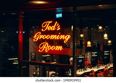 London, United Kingdom - February 01, 2019: Yellow Neon Script Text Logo On Ted's Grooming Room - Subsidiary Of Ted Baker - Barber Shop At One Of Their UK Branches