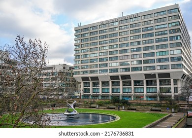 London, United Kingdom - February 02, 2019: St Thomas Hospital Building Wall Near London Bridge, Green Lawn With Fountain In Foreground. It Is Academic Health Science Centre And Teaching Hospital