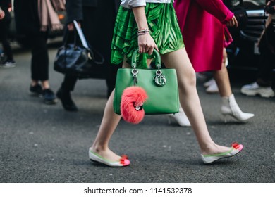 LONDON, United Kingdom- February 16 2018: Lady on the street during the London Fashion Week with a green Dior handbag