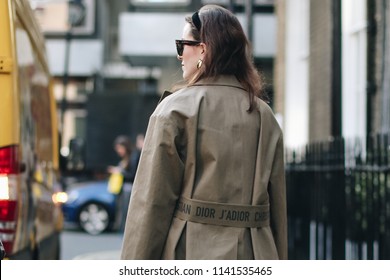 LONDON, United Kingdom- February 16 2018: Lady On The Street During The London Fashion Week Wearing Beige Dior Jacket 