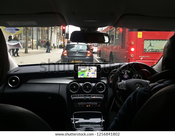 LONDON, UNITED KINGDOM- JANUARY 1,\
2018: Interior dashboard design and decoration of \'MERCEDES BENZ C\
CLASS W205\' with traffic around Hyde park- England,\
UK