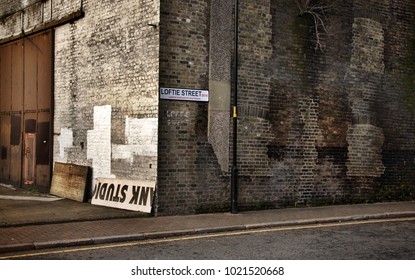 London, United Kingdom - January 27th, 2007: Vintage Look Corner Of Loftie Street In Southwark With Dirty Old Brick Wall.