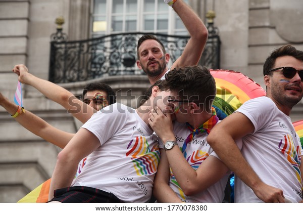 London, United Kingdom, July 6 2019: Gay happy Pride\
men kissing and parading Parade on the 6th of July 2019 London,\
UK.