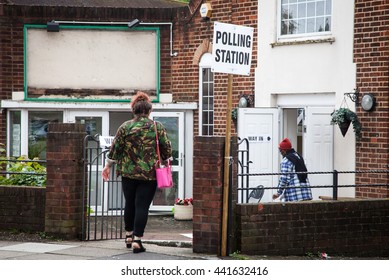 LONDON, UNITED KINGDOM - JUNE 23: A man holding an umbrella passes by a polling station during the British EU Referendum in London, United Kingdom on June 23, 2016.